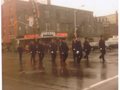 Police march downtown, in front of what is now La Reina.