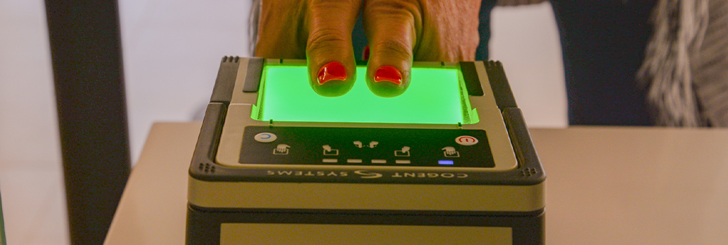 Two thumbs on fingerprinting machine