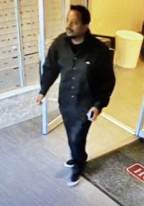 Man exiting apartment building